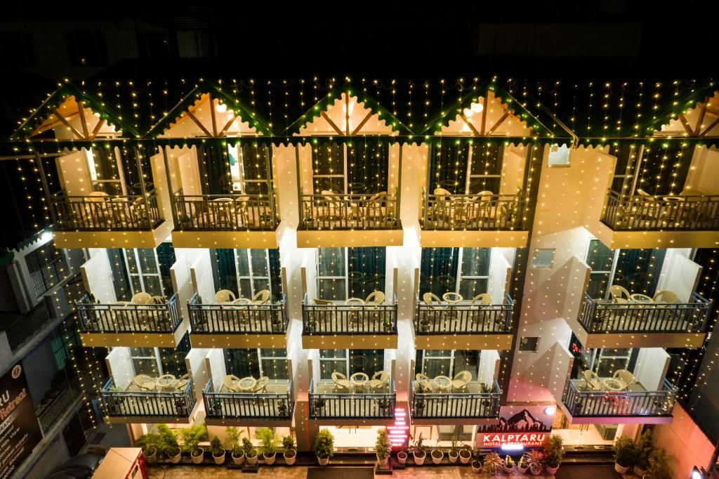 an aerial view of a building with christmas lights at Kalptaru The Kumaon Retreat in Bhowāli