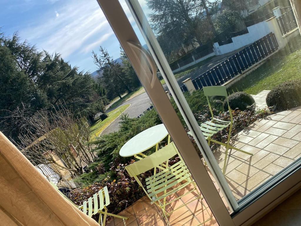 a view of a patio with a table and chairs at Quite House in Villiers-le-Morhier