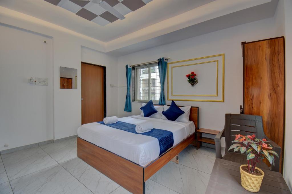 ein Schlafzimmer mit einem großen Bett mit blauen Kissen in der Unterkunft 2 Bhk Apartment in Dāpuri