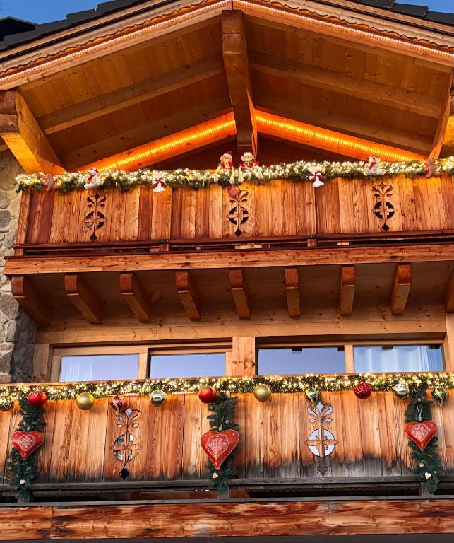a wooden house with christmas decorations on it at Chalet La Renarde in Villars-sur-Ollon