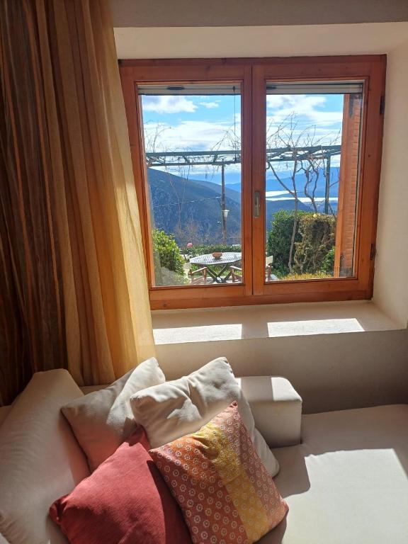 a room with a window with a view of a mountain at Delphi Sunset Apartment in Delphi