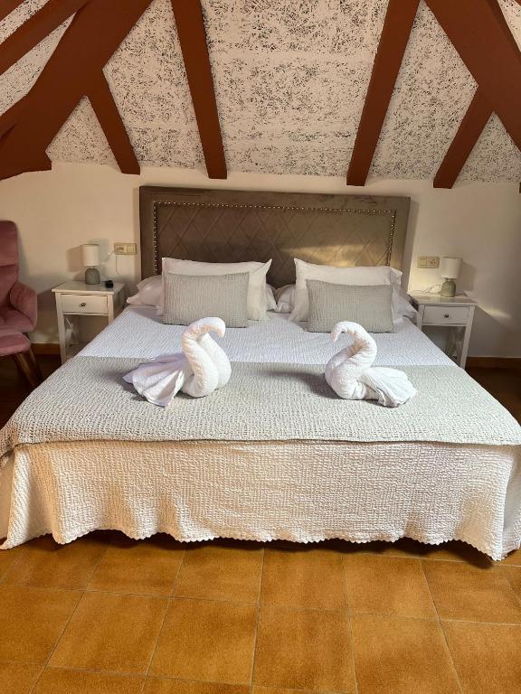 a bedroom with a bed with towels on it at CasaNova in Combarro