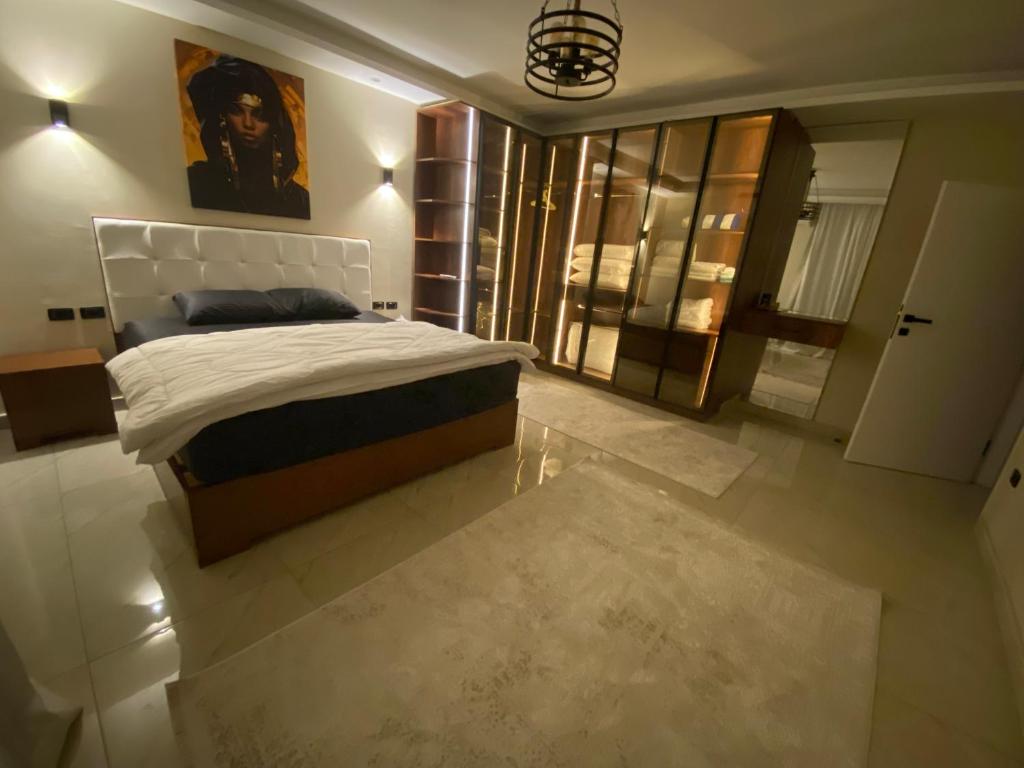 a bedroom with a king sized bed and a window at Heliopolis Ultra Luxury Panoramic Apt Near Cairo Airport in Cairo