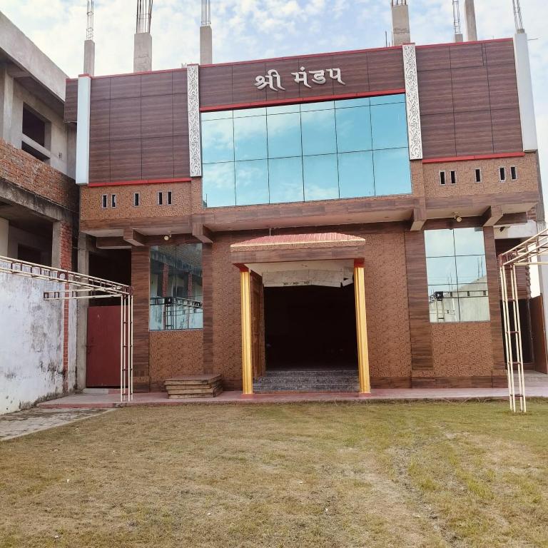 a large brick building with a large entrance at SHREE MANDAP HOTEl 