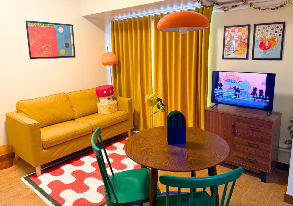 a living room with a yellow couch and a table at The Retrograde at The Crestmont in Manila