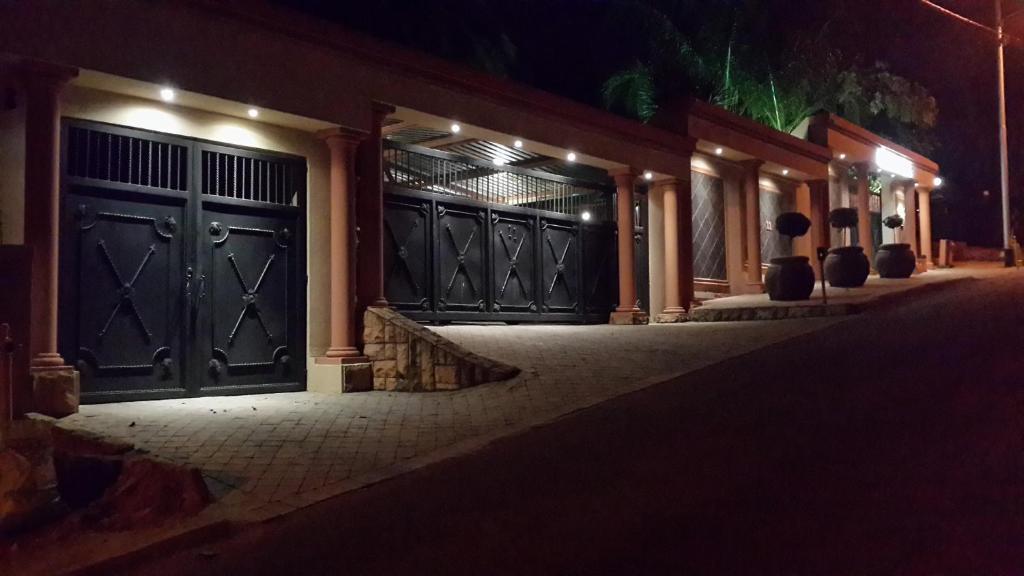 a house with two garage doors at night at The Cedars Bed and Breakfast in Centurion