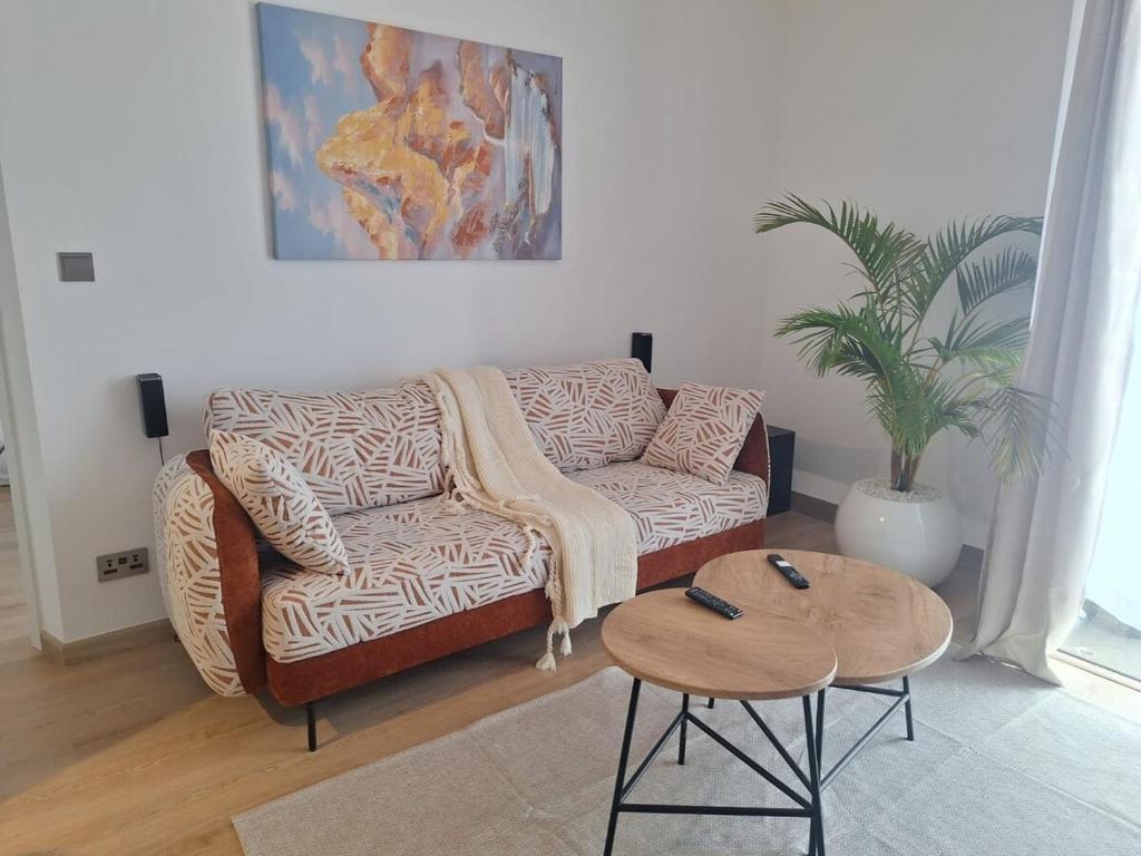 a living room with a couch and a table at Tatu Nest in Tatu City