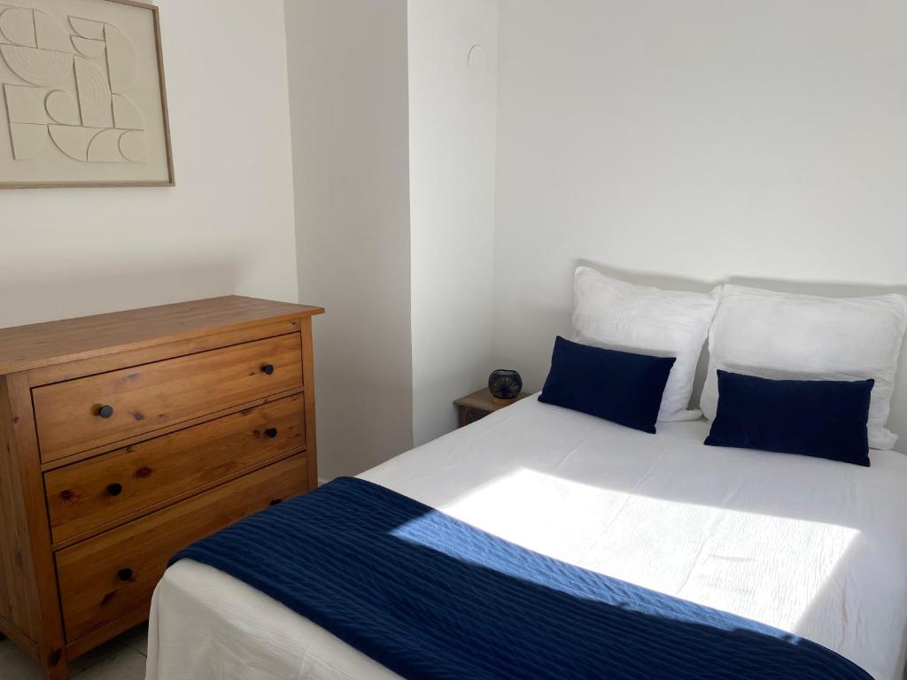 a bedroom with a bed and a wooden dresser at Montpellier - Corum - Louis Blanc in Montpellier