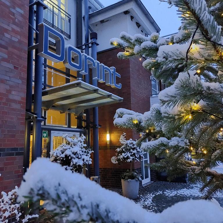 a sign for the entrance to a hotel in the snow at Dorint Strandresort & Spa Ostseebad Wustrow in Wustrow