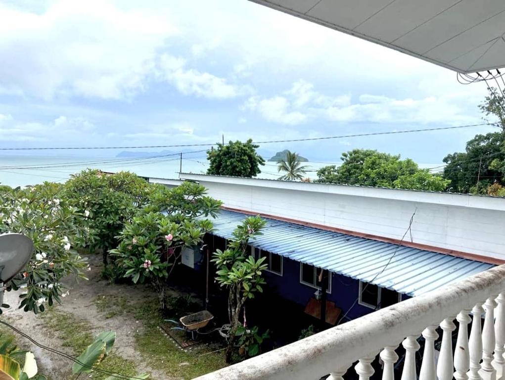 a balcony view of a house with the ocean in the background at BlackSand Guests House Langkawi in Huma
