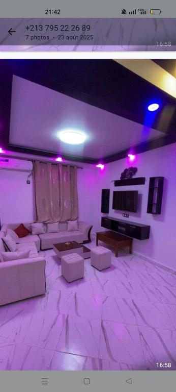 a living room with purple lights and a couch at Saket plage in Bejaïa