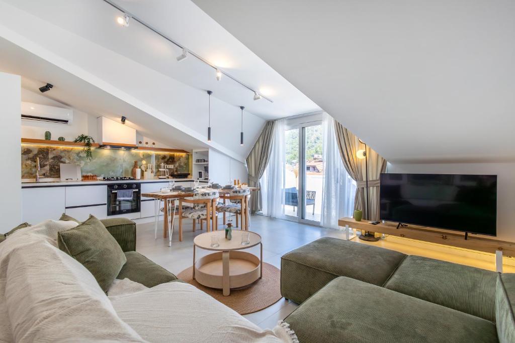a living room with a couch and a tv at Vera home in Marmaris