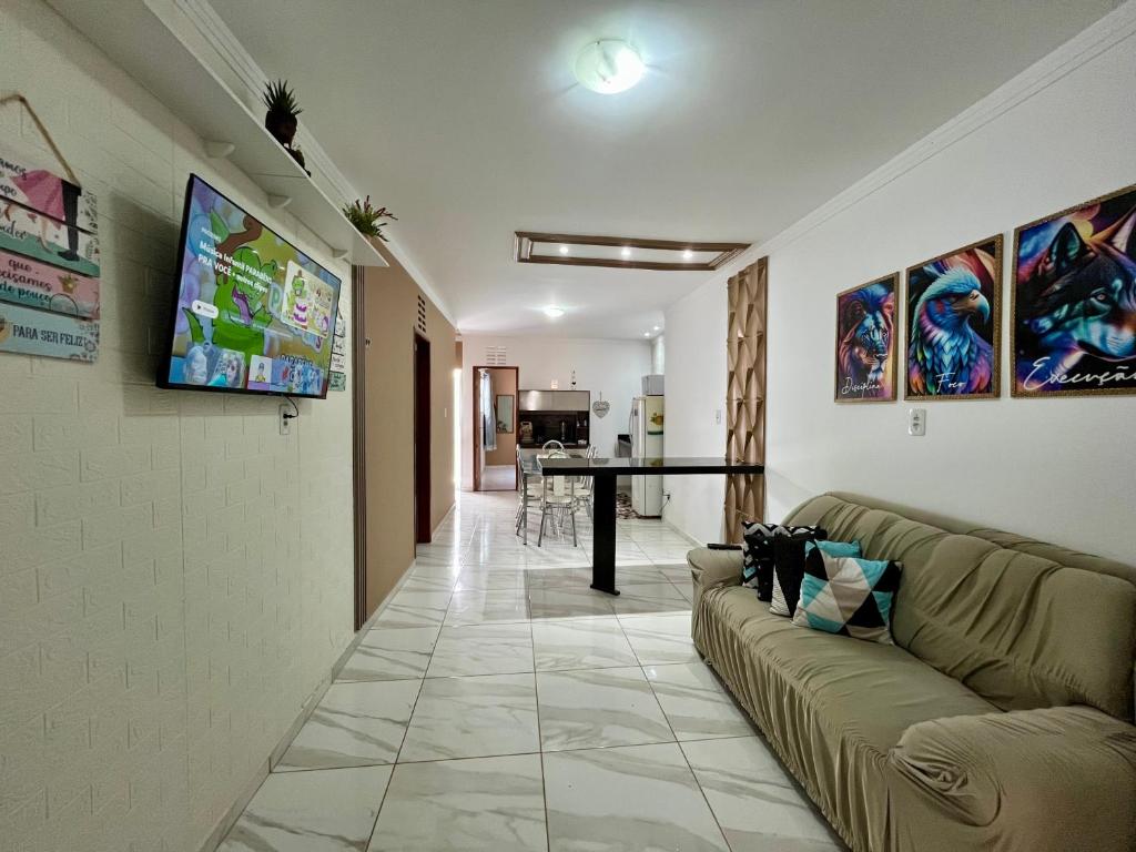a living room with a couch and a table at Serraruna House no centro histórico in Araruna
