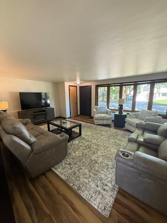 a living room with two couches and a television at Three Bedroom Ranch walking distance to Lambeau in Green Bay
