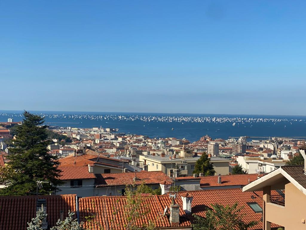 a view of a city with the ocean in the background at Le Pergole in Trieste