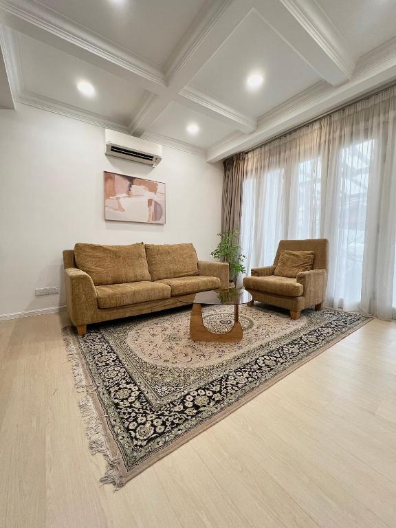 a living room with a couch and a table at Roomah Puteh in Shah Alam