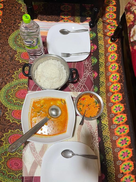 a table topped with dishes of food on a table at Liptora Homestay in Bandarawela