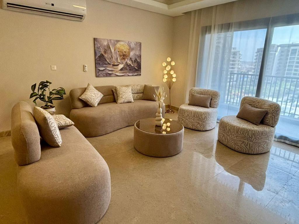 a living room with a couch and two chairs and a table at zayed in Sheikh Zayed
