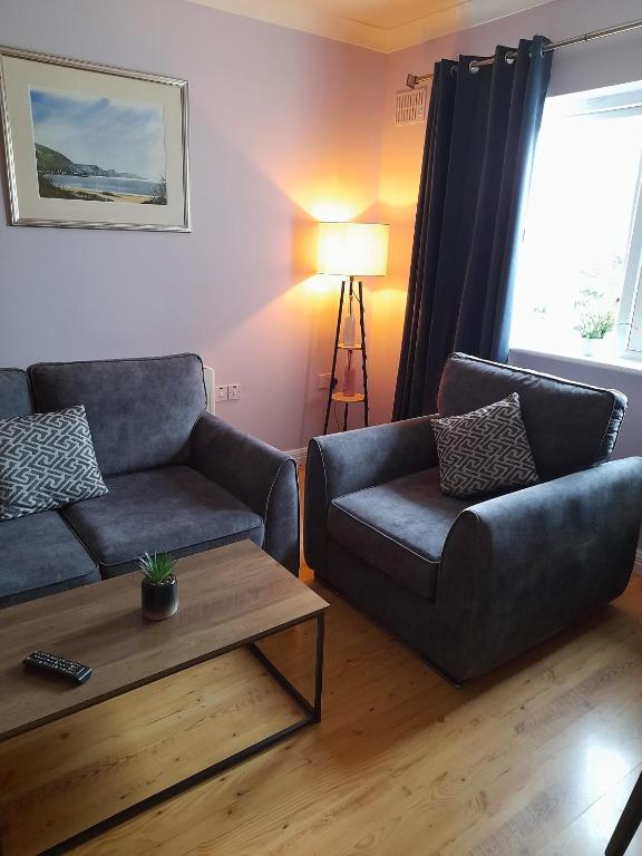 a living room with a couch and a coffee table at Kathleen's Apartment includes Car Parking in Galway
