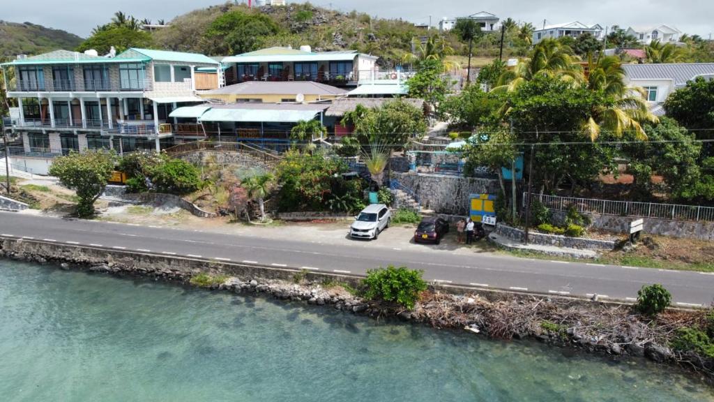 a car parked on the side of a road near the water at Le Pandanus in Rodrigues Island