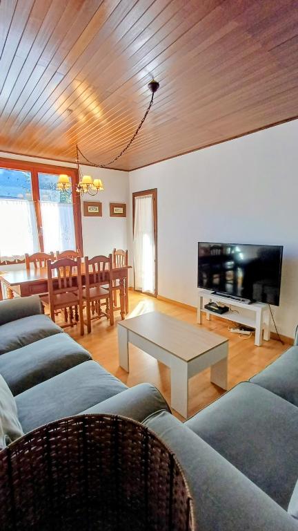 a living room with two couches and a table at APARTAMENTO SAPPORO VIELHA in Vielha