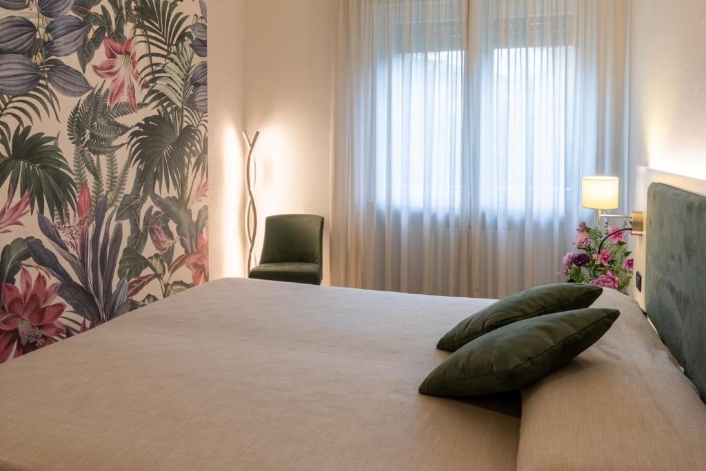 a bedroom with a large bed with a window at Somma Relax Apartment in Sommacampagna