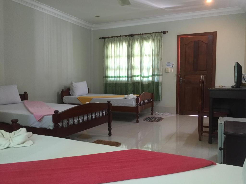 Postel nebo postele na pokoji v ubytování IKI IKI Guesthouse
