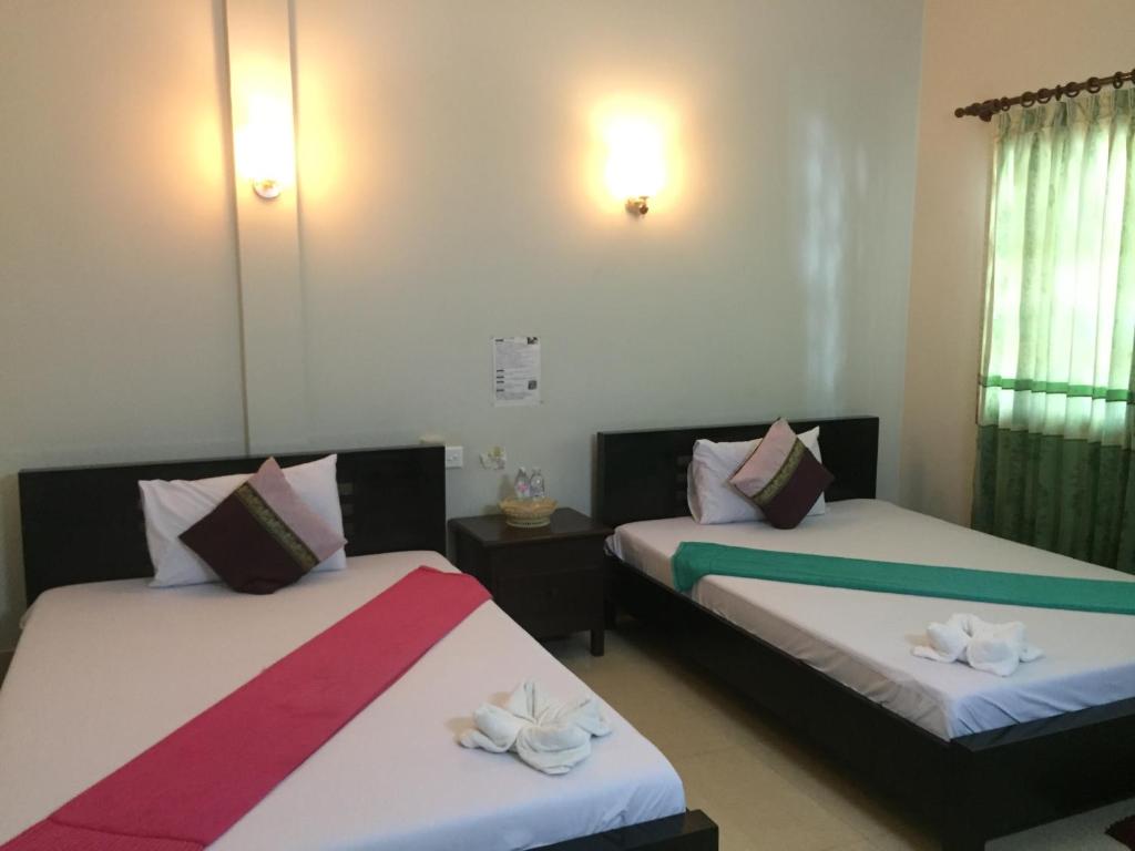 Postel nebo postele na pokoji v ubytování IKI IKI Guesthouse