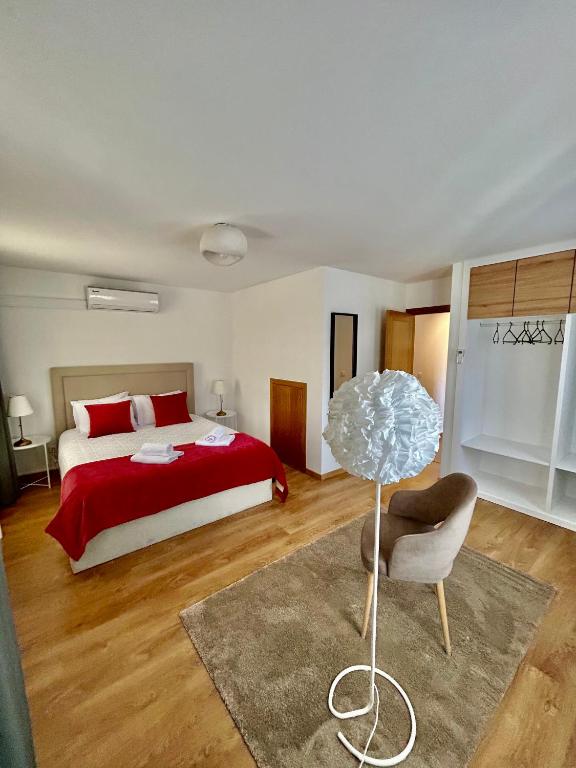 a bedroom with a bed and a table and a chair at Aquae Flaviae Urban Stay - Charm in Chaves