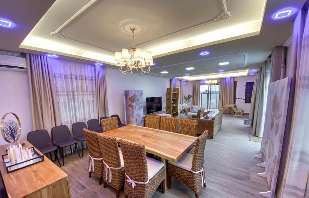 a dining room with a wooden table and chairs at Modern Cosy Villa in Pointe aux Biches