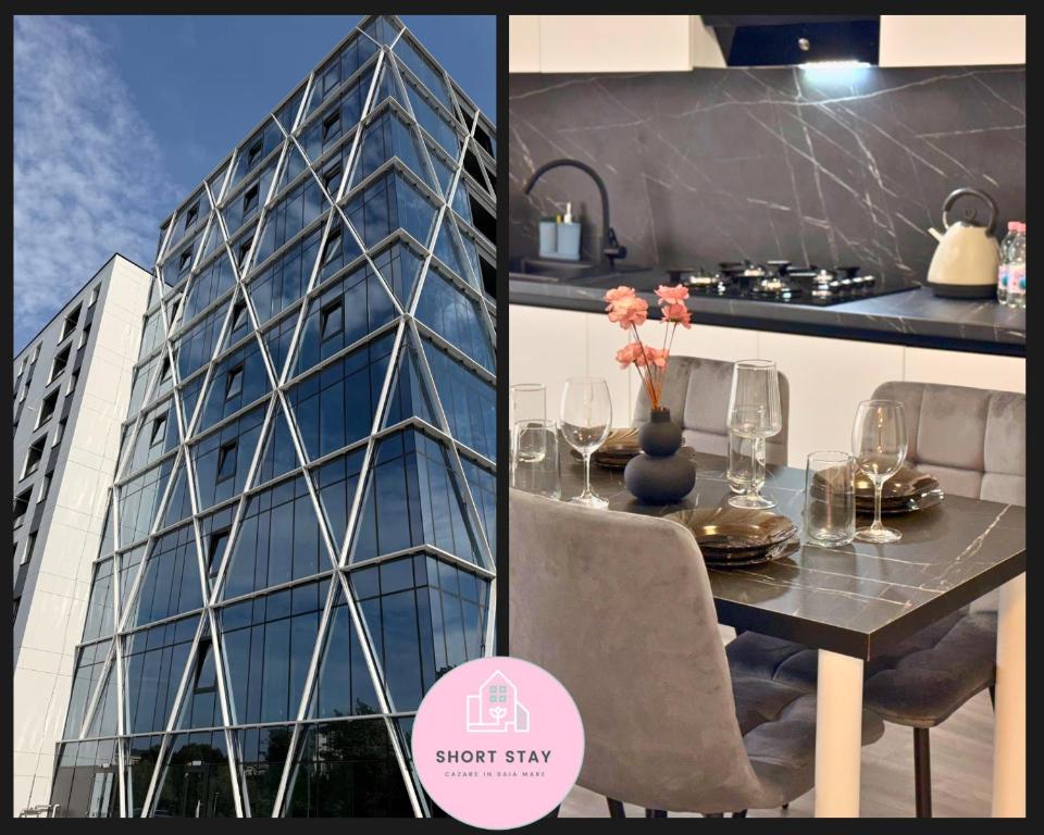 un comedor con mesa y un edificio en Short Stay Urban, en Baia Mare