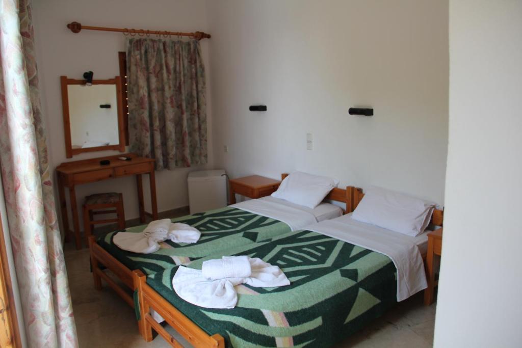 Postel nebo postele na pokoji v ubytování Hotel Alkyon