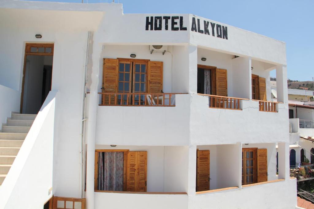 a white building with a hotel adviser sign on it at Hotel Alkyon in Hora Sfakion