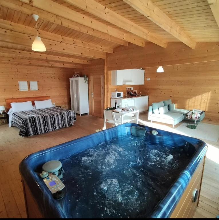 a large bath tub in a room with a bedroom at Las Casas de Durón in Durón