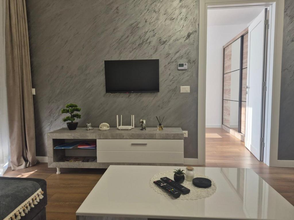 a living room with a tv on a wall at Apartment VIP in Subotica