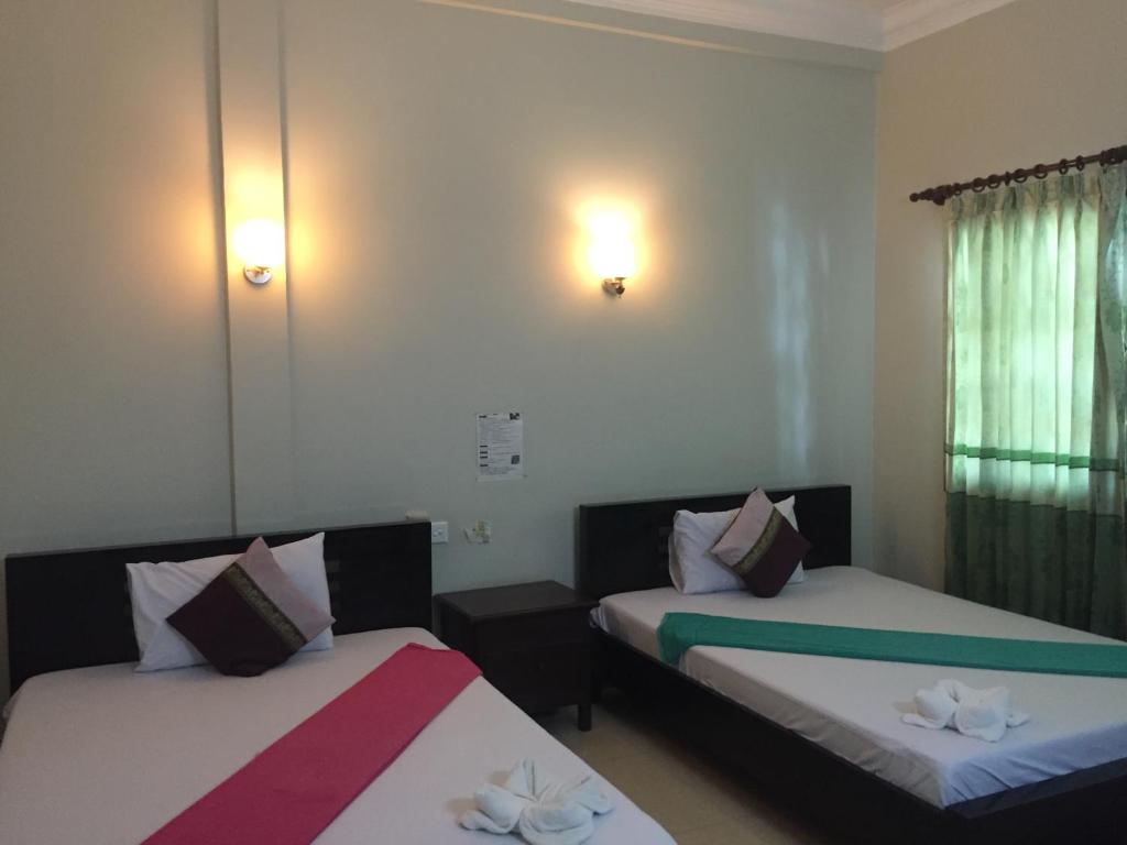 Postel nebo postele na pokoji v ubytování IKI IKI Guesthouse