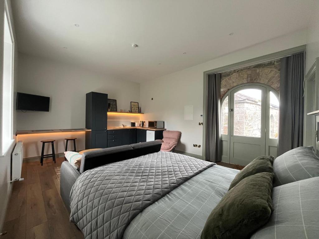 a bedroom with a bed and a couch at Crossdrum Courtyard Accommodation in Oldcastle