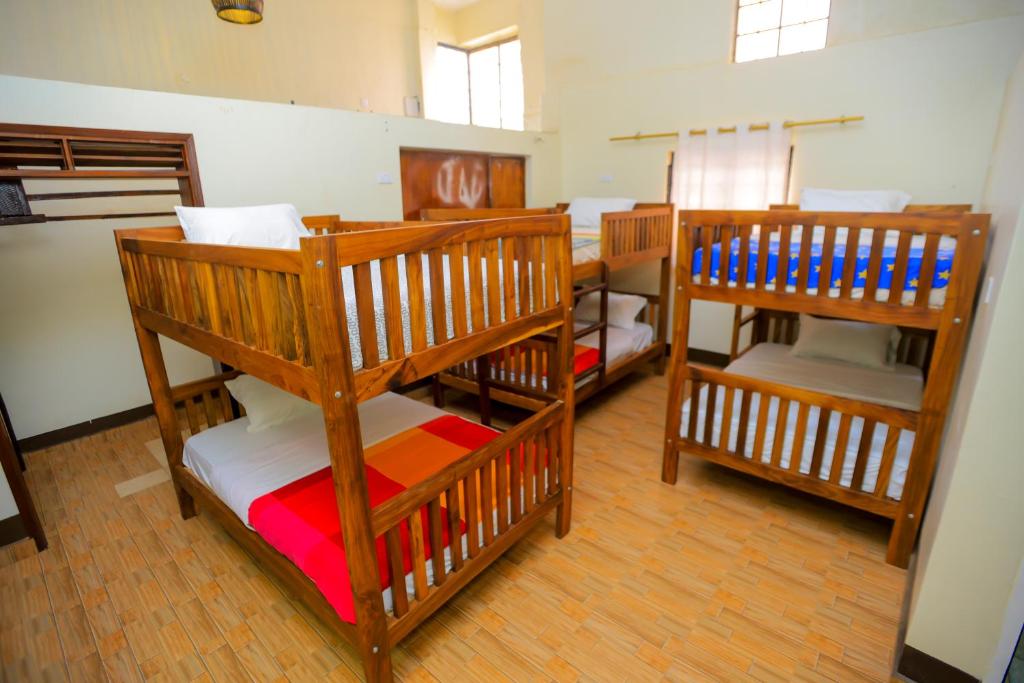 a group of bunk beds in a room at Hotel Acacia View in Kampala