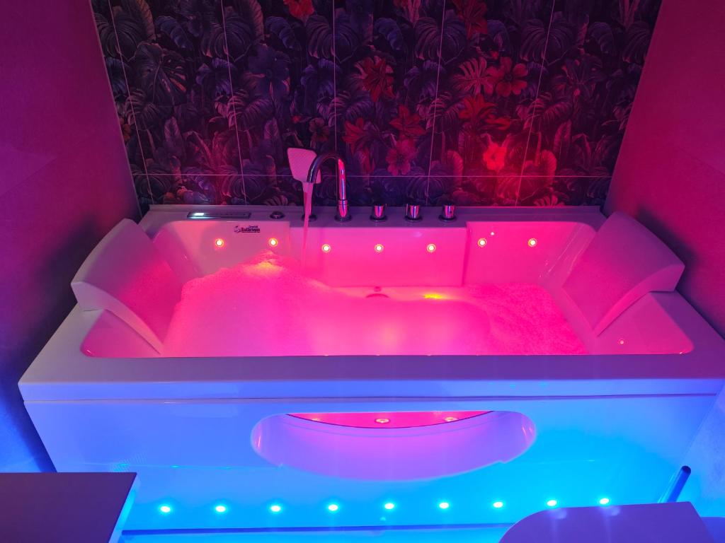 a pink bath tub with a red light in it at Galway Paradisus in Galway