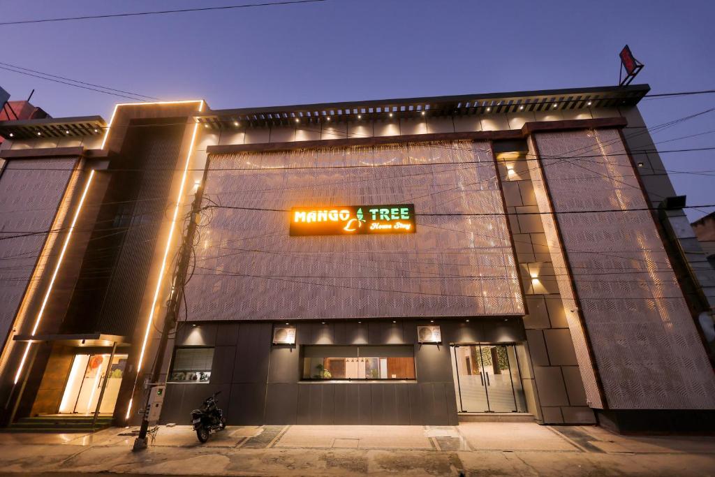 a building with a sign on the side of it at Hotel Mango Tree, Vrindavan in Vrindāvan