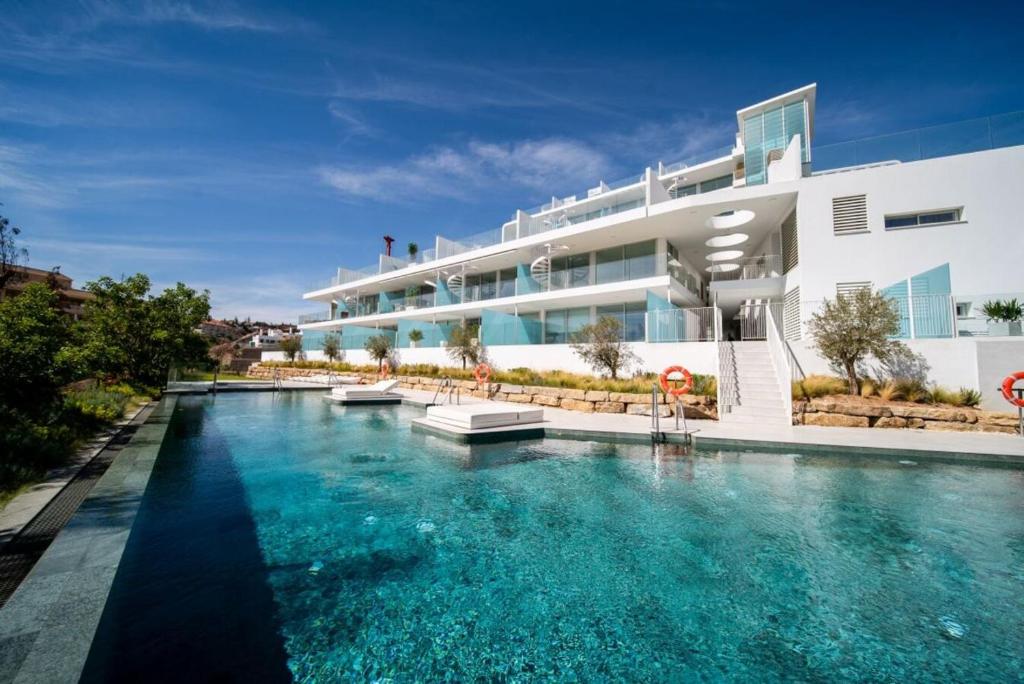 a large swimming pool in front of a building at Mara's Apartments Higuerón - Azzurro Med Two Collection - Seaviews in Fuengirola