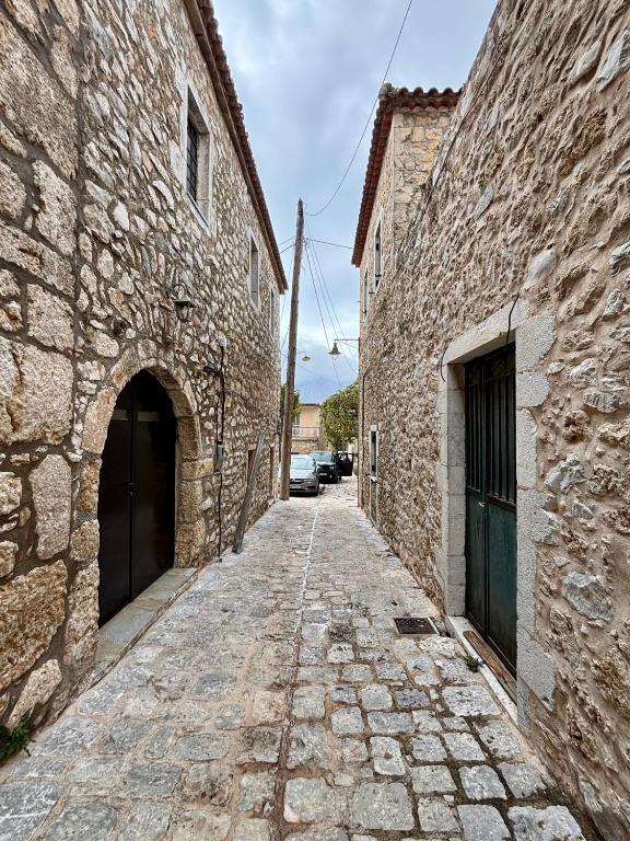 an alley in an old stone building at Alfa25 in Oitylo