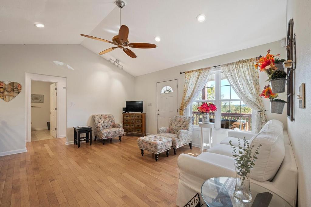 a living room with a couch and a ceiling fan at 3BR Nature Retreat Near Lake James and Morganton in Morganton