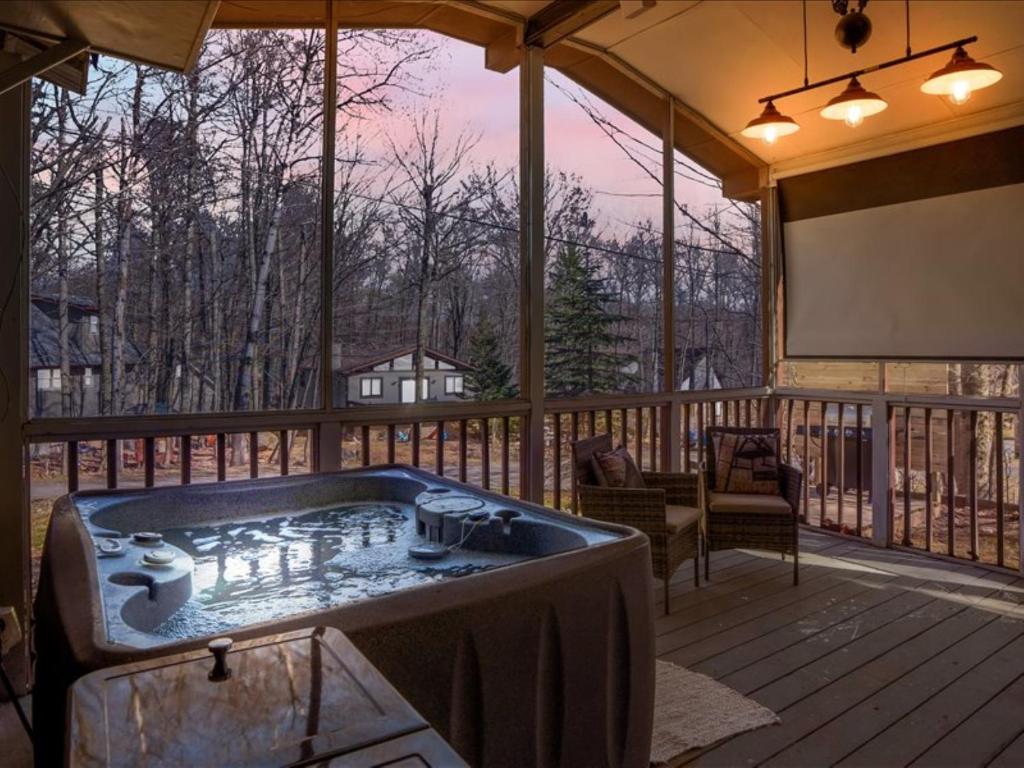 a jacuzzi tub on a screened in porch with a screen at Pocono - Home away from home in Tobyhanna