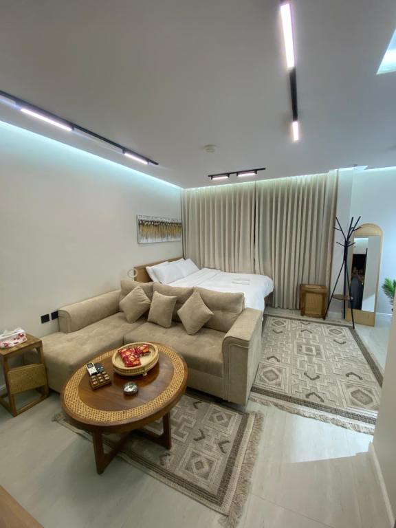 a living room with a couch and a bed at سندباد in Riyadh