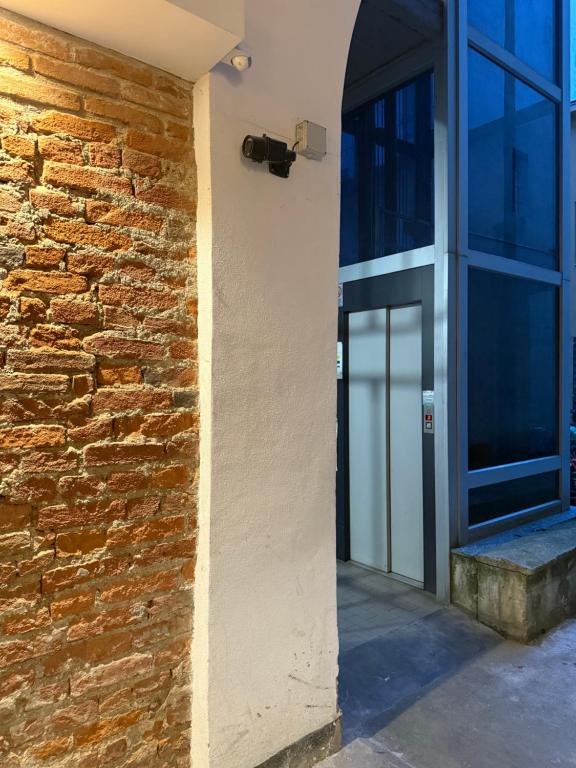 an entrance to a building with a brick wall at Little House Amedeo in Turin