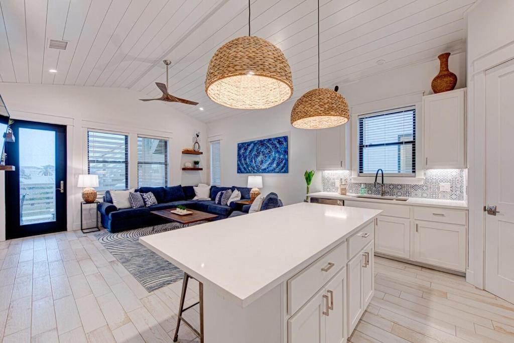 a kitchen and living room with a couch and a table at Double Dunes! Heated Pool with Ocean Views! in Port Aransas