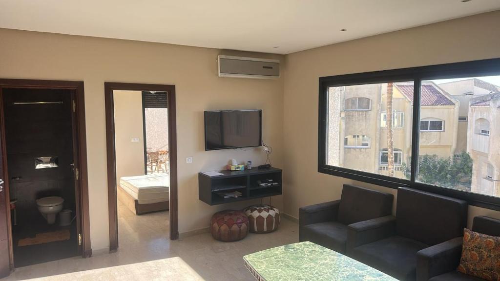a living room with a couch and a television at Appart For Rent Kech in Marrakech