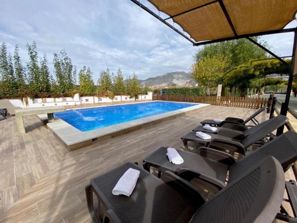 a pool with chairs and a swimming pool at Villa Murataj in Ksamil