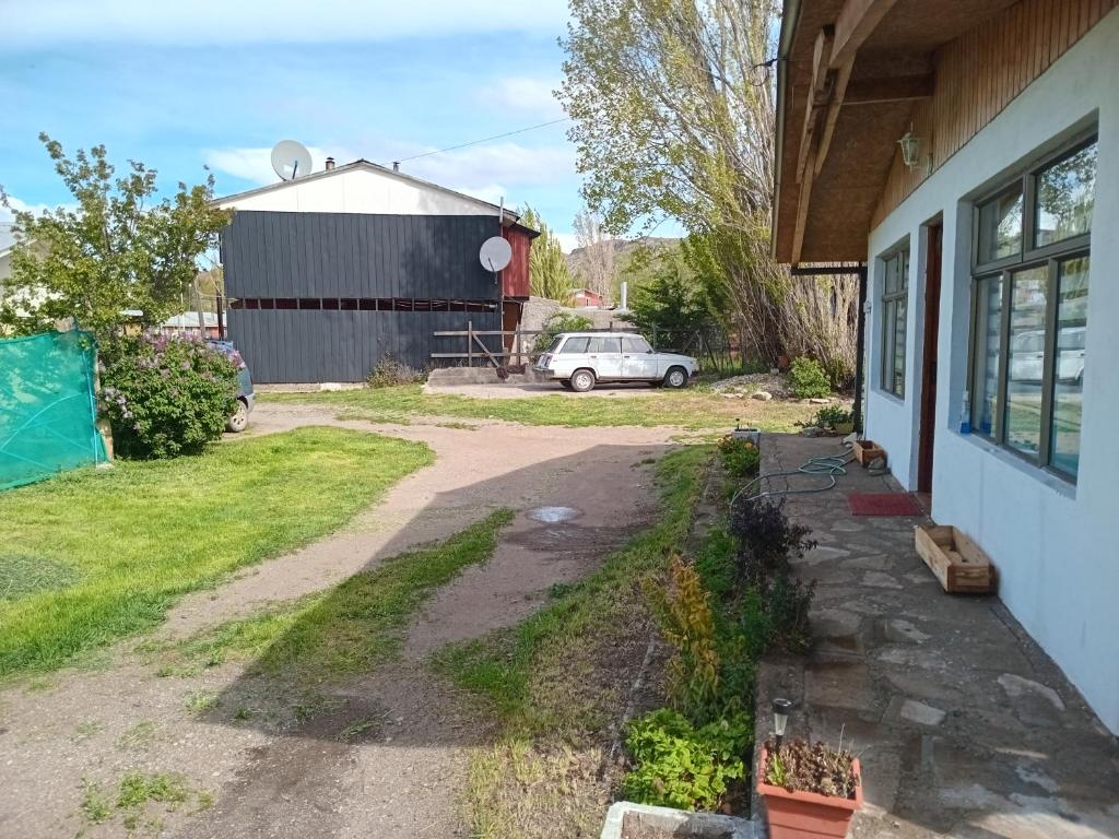 a driveway outside of a house with a car parked at cabaña milita in Chile Chico